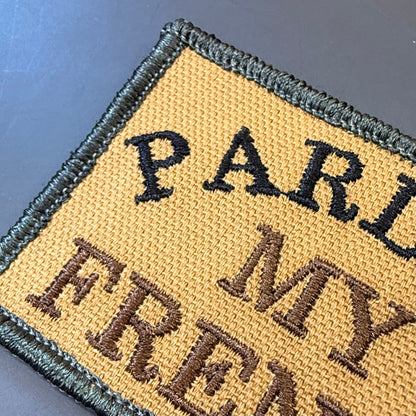 Pardon My French patch in tan with black lettering and border, close-up of embroidery