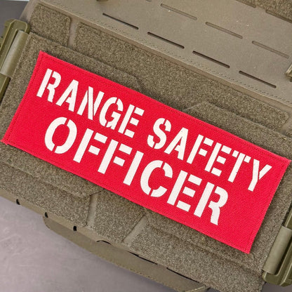 Range Safety Officer Patches & ID Panels patch in red with white Range Safety Officer lettering, mounted on a tan plate carrier