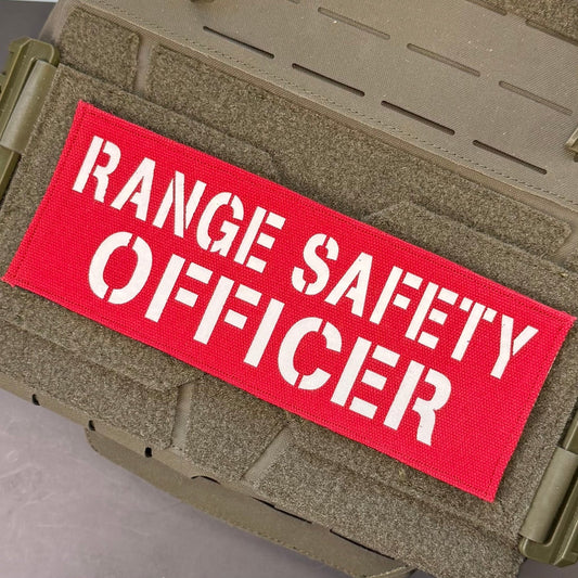 Range Safety Officer Patches & ID Panels patch in red with white Range Safety Officer lettering, mounted on a tan plate carrier
