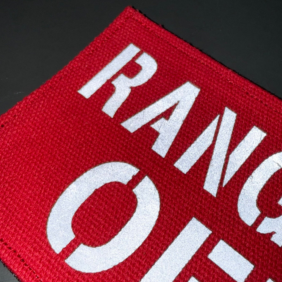 Range Safety Officer Patches & ID Panels patch in red with white Range Safety Officer lettering, close-up of lettering