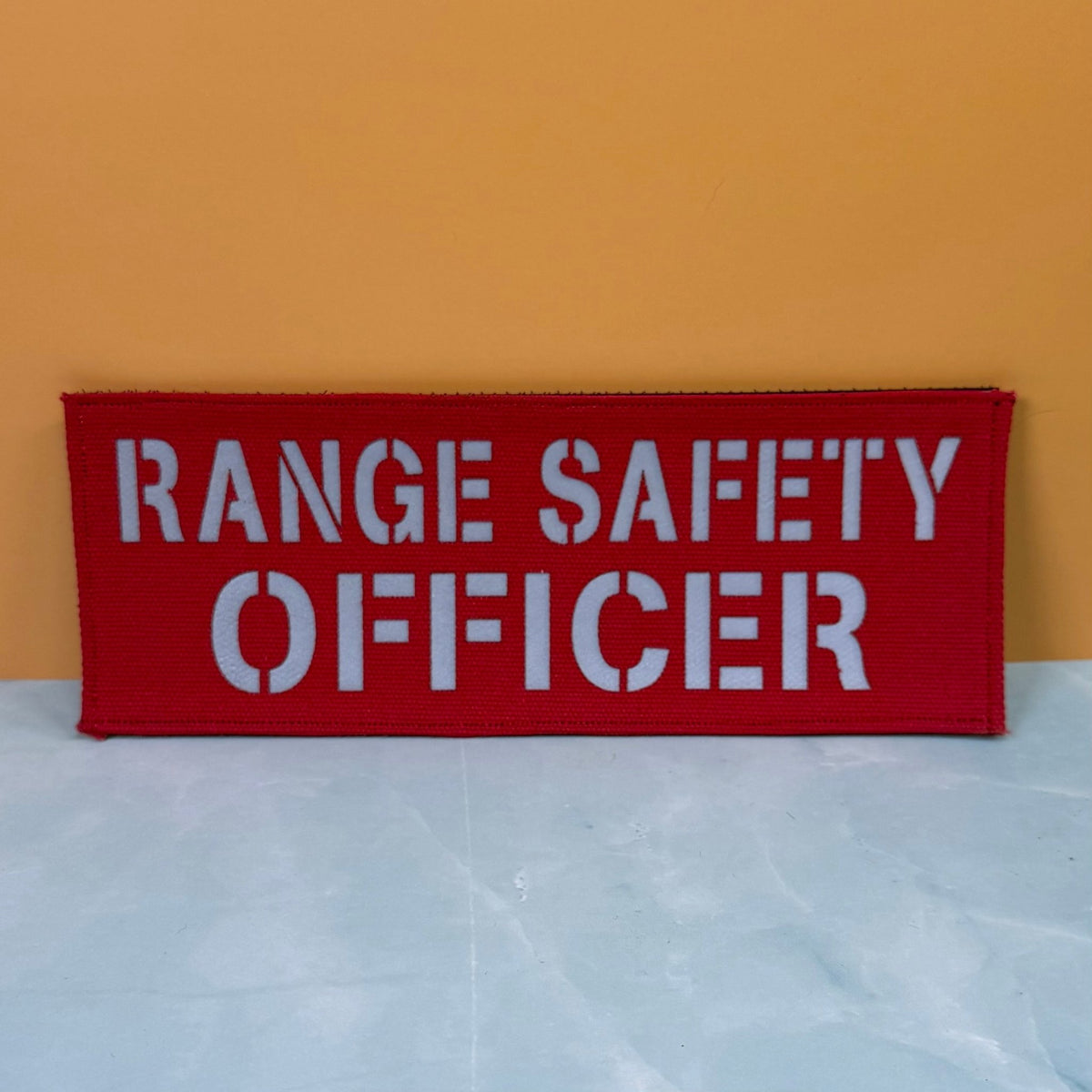 Front view of Range Safety Officer Patches & ID Panels patch in red with white Range Safety Officer lettering