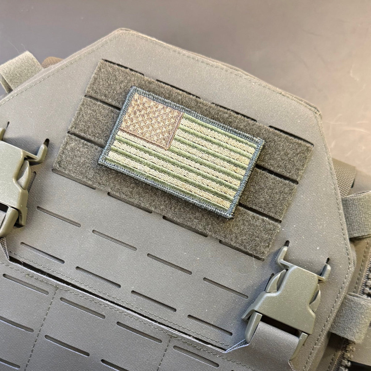 Subdued FDE Tactical American Flag patch in subdued tan and green American flag, mounted on a tan plate carrier