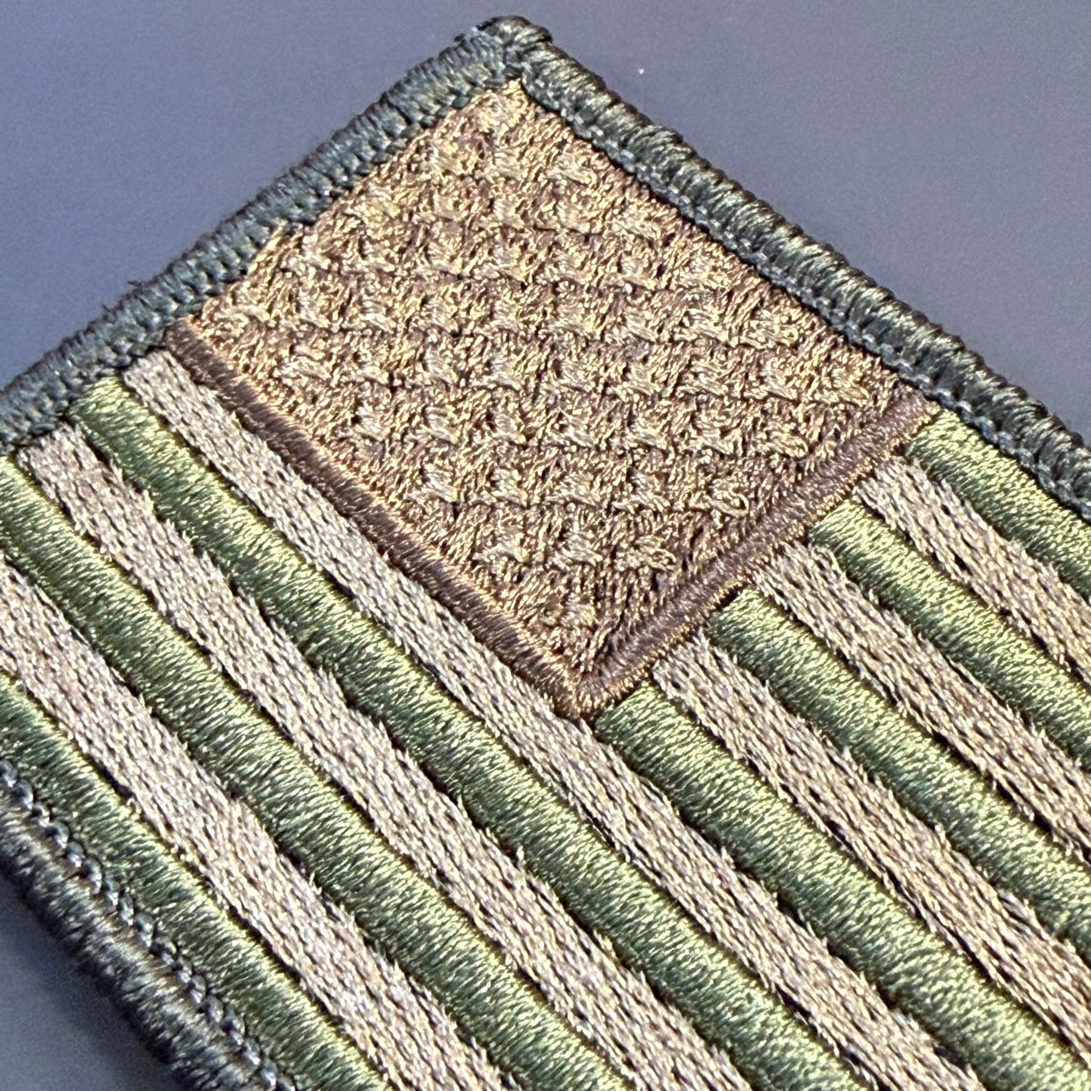 Subdued FDE Tactical American Flag patch in subdued tan and green American flag, close-up of embroidery