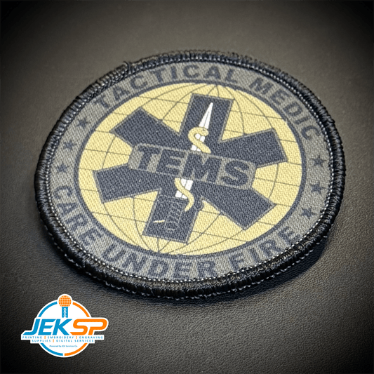 Front view of Tactical Medic TEMS – Care Under Fire patch in olive green and black with a star-of-life symbol and TEMS lettering