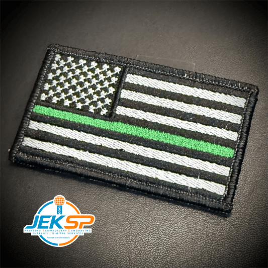 Front view of Thin Green Line Tactical American Flag patch in black and white American flag with one green stripe