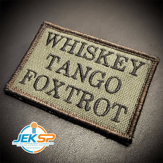 Front view of Whiskey Tango Foxtrot WTF patch in olive green with black lettering